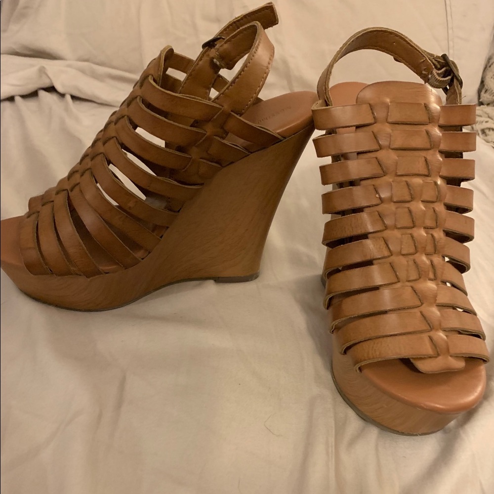 Nude/tan/beige high platform wedges.